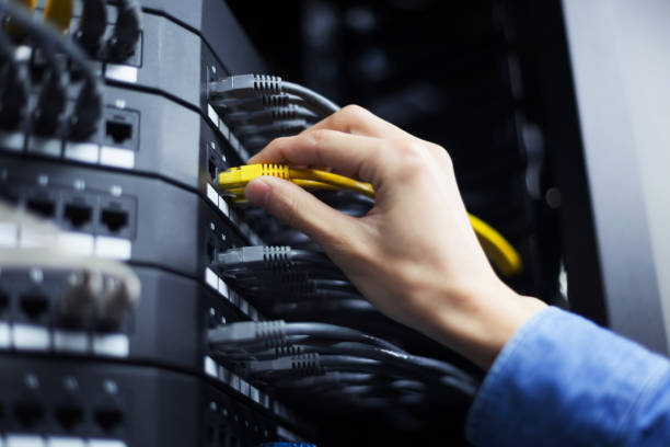 IT engineer installing network equipment in server rack